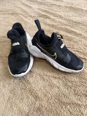 Nike Kids Black and White Slip-On Sneakers with Gold Swoosh